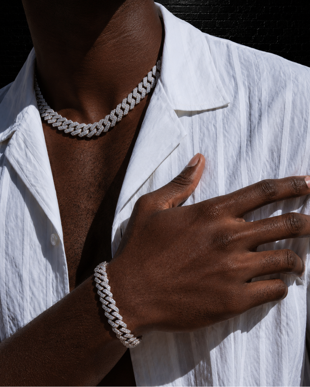 Person wearing a white braided bracelet on a white shirt
