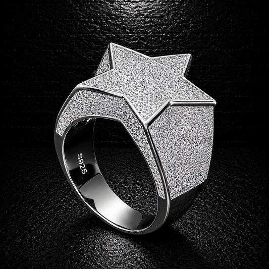 Silver star-shaped ring on a black background